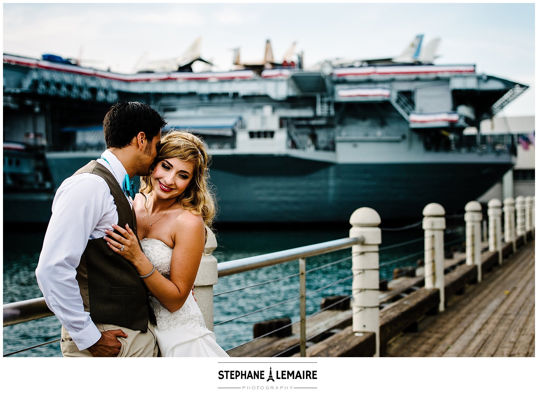 photo of groom kissing bride at the USS Midway
