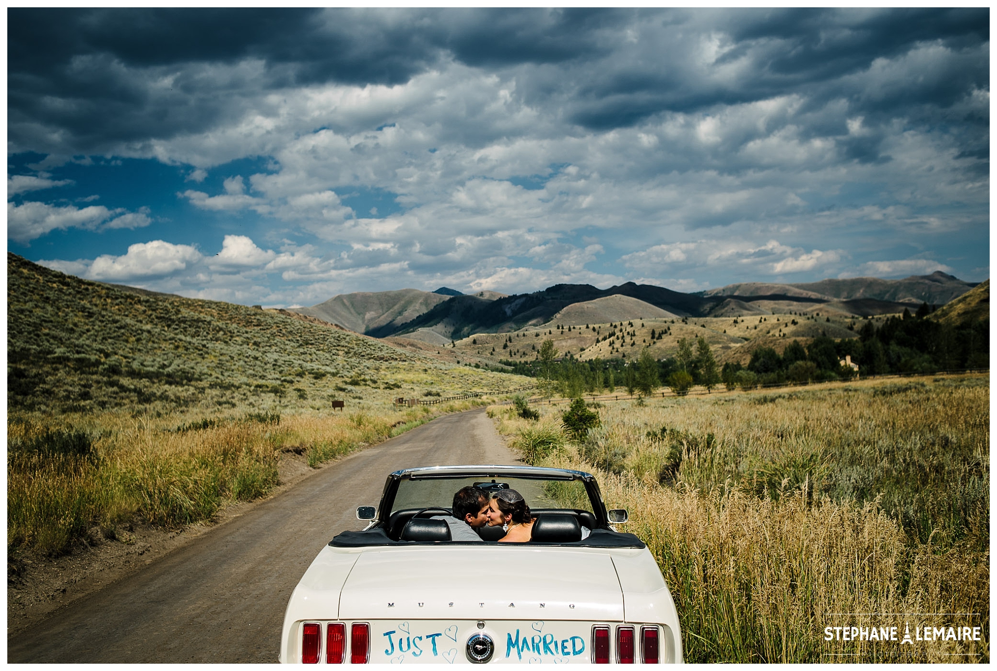 Bride and Groom driving away in white mustang at Sun Valley Wedding