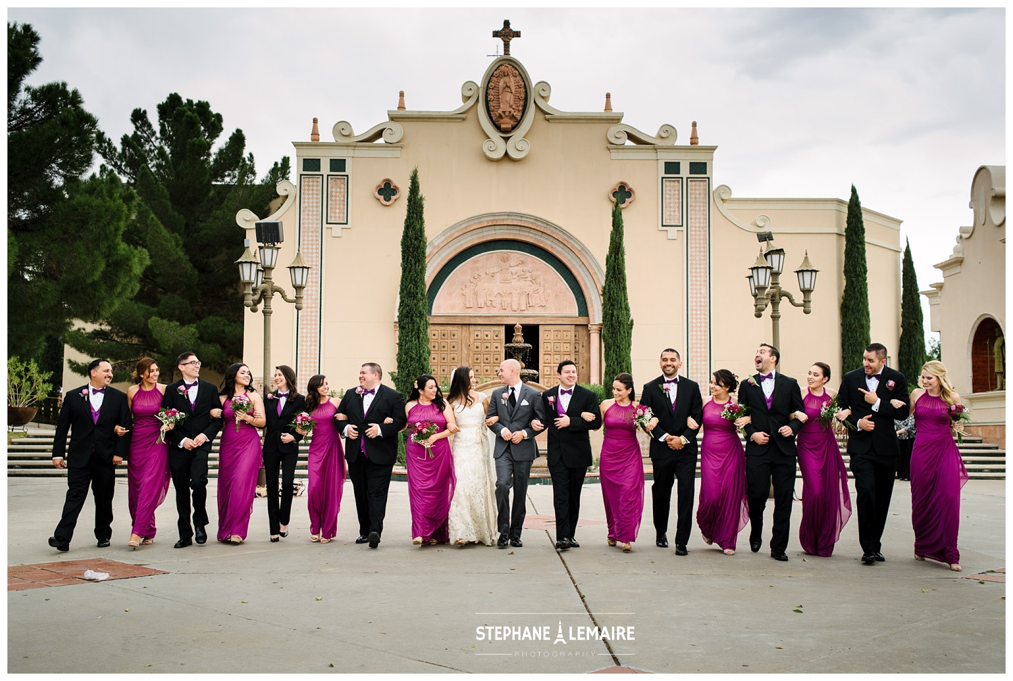 Bridal Party walking in front of saint pius church in el paso 