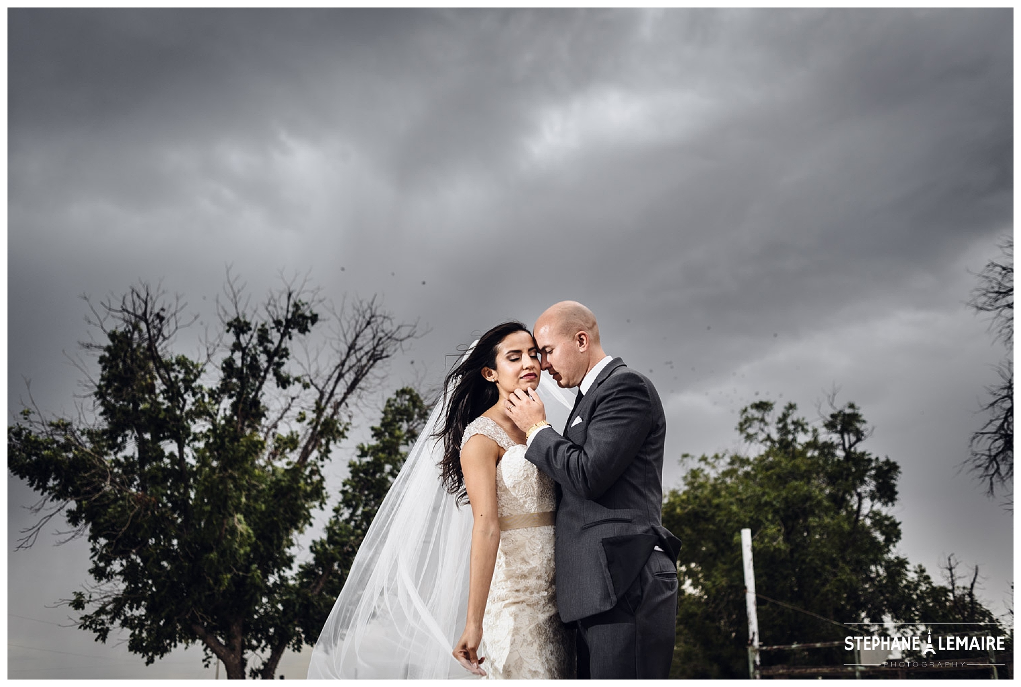 Bride and Groom portrait with dramatic sky at Jardines Arco Iris Wedding venue 