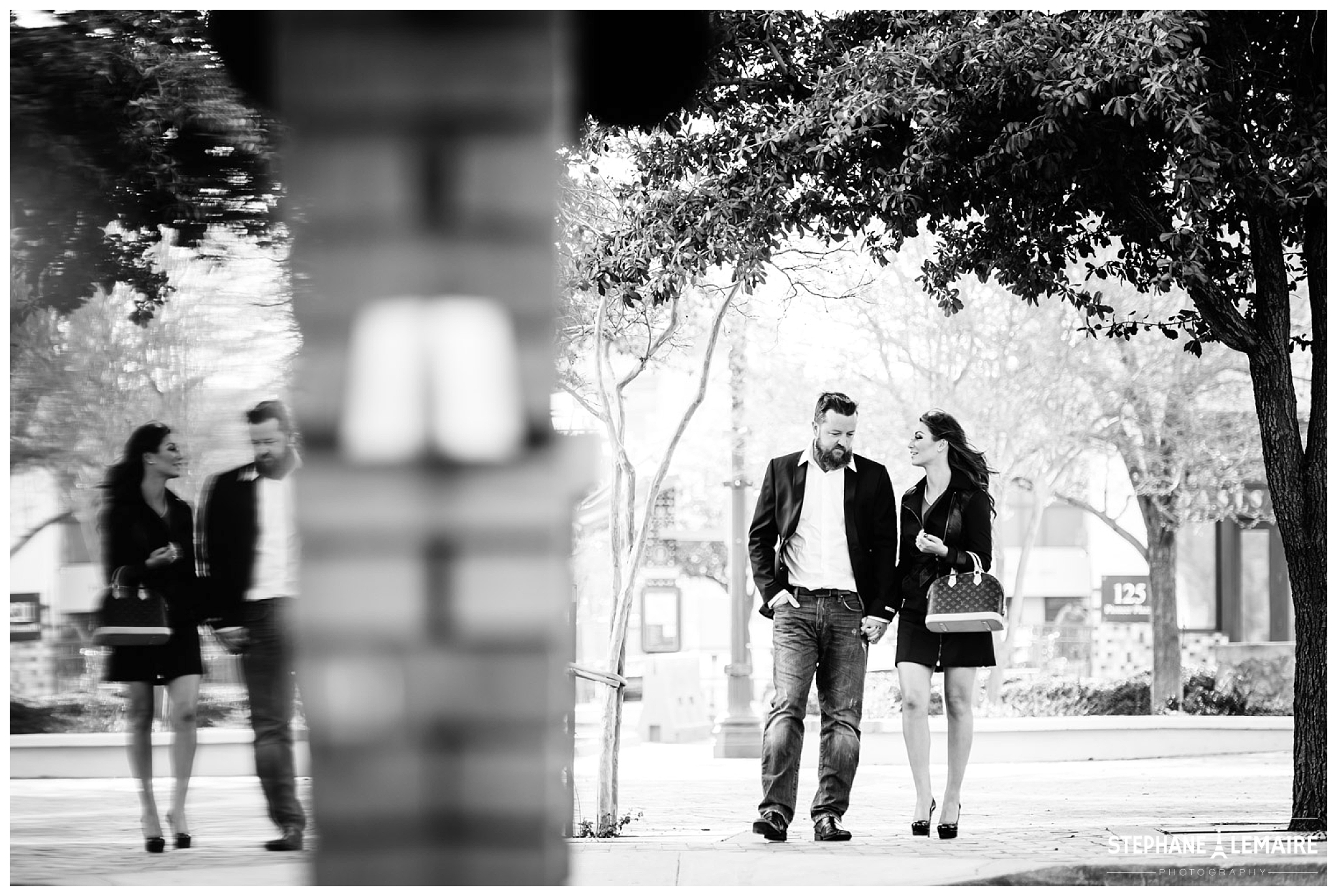 Black and White photo of a couple walking in the street