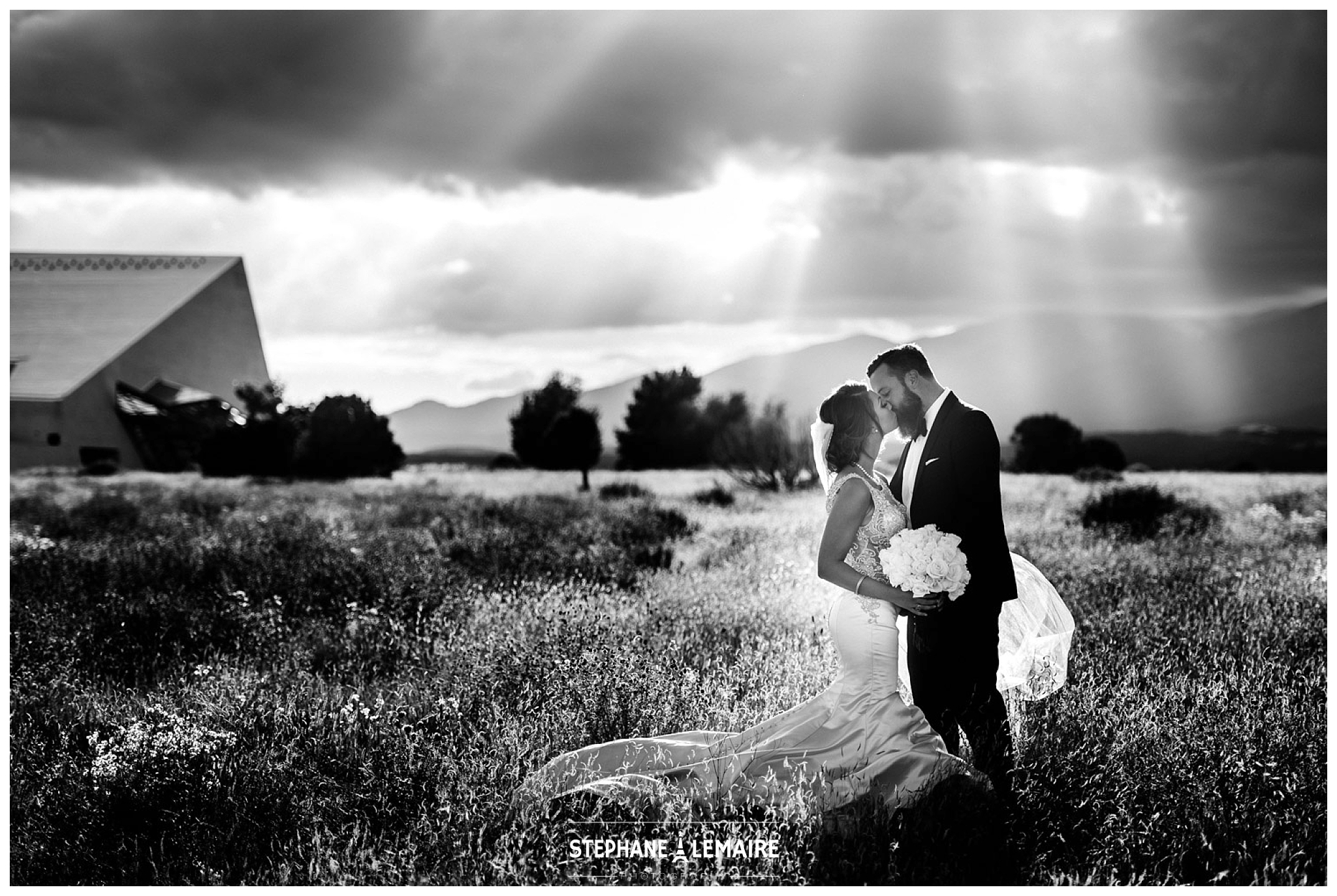Black and White portrait of Bride and Groom in field at Spencer theater wedding in Ruidoso by Stephane Lemaire Photography 