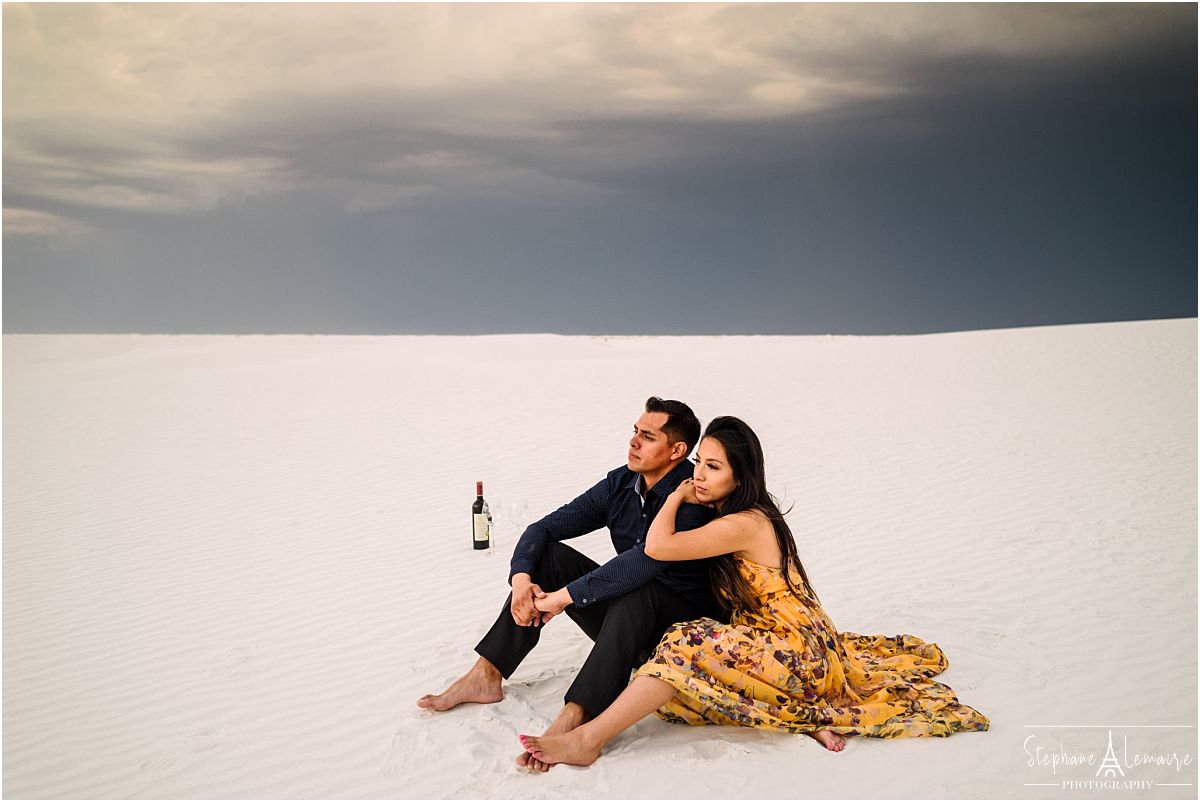 Couple sitting at White Sands National Monument by stephane Lemaire photography