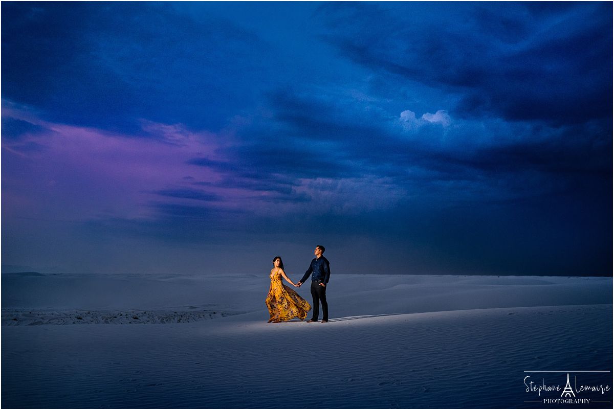 Couple holding hands at sunset at White Sands National Monument by stephane Lemaire photography