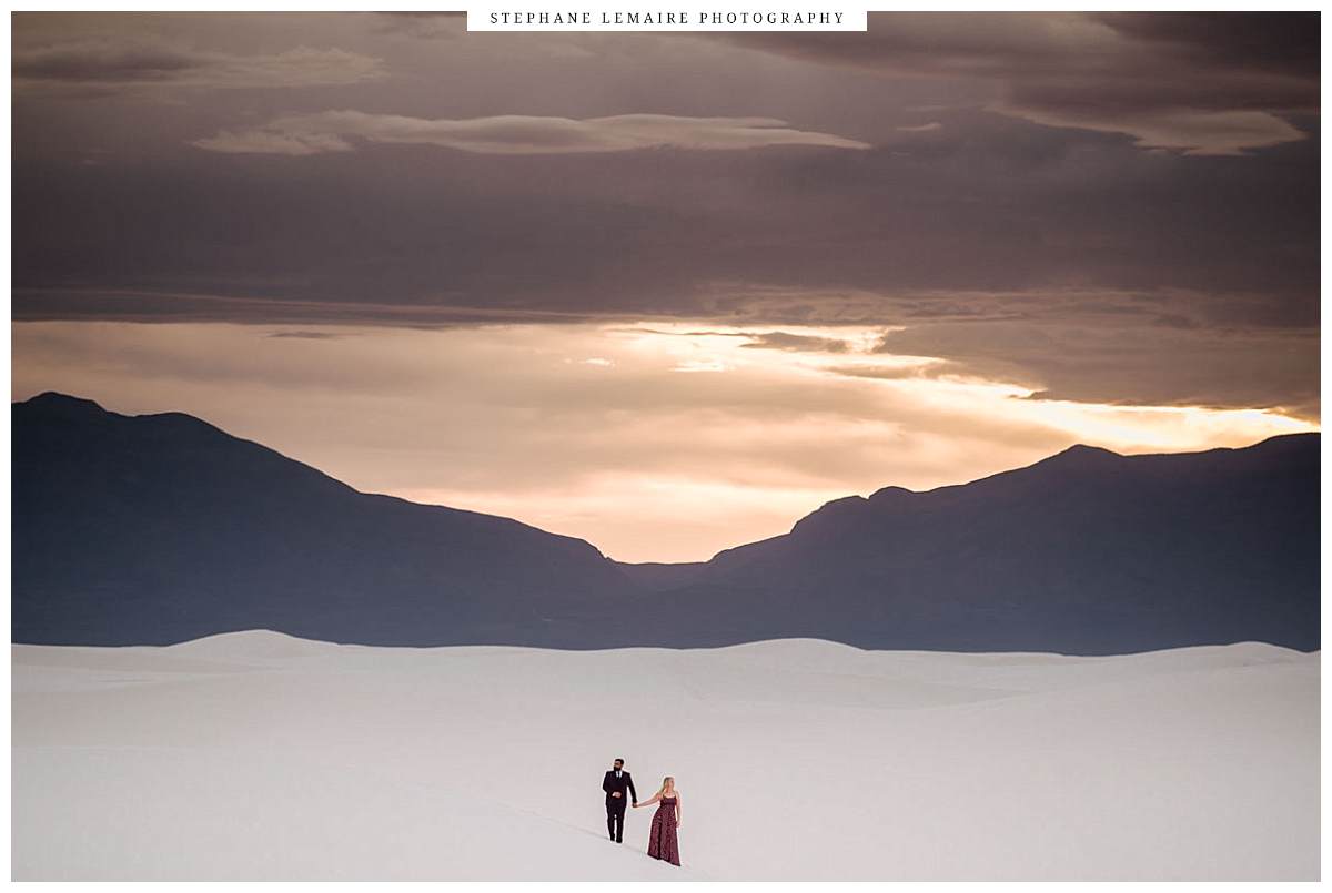 Couple standing on the dune during their engagement session at White Sands