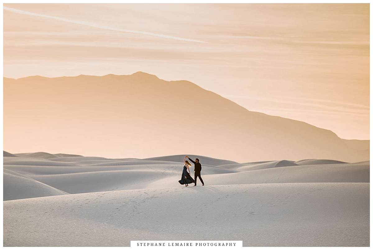 Couple dancing on a dune at White Sands for their engagement session