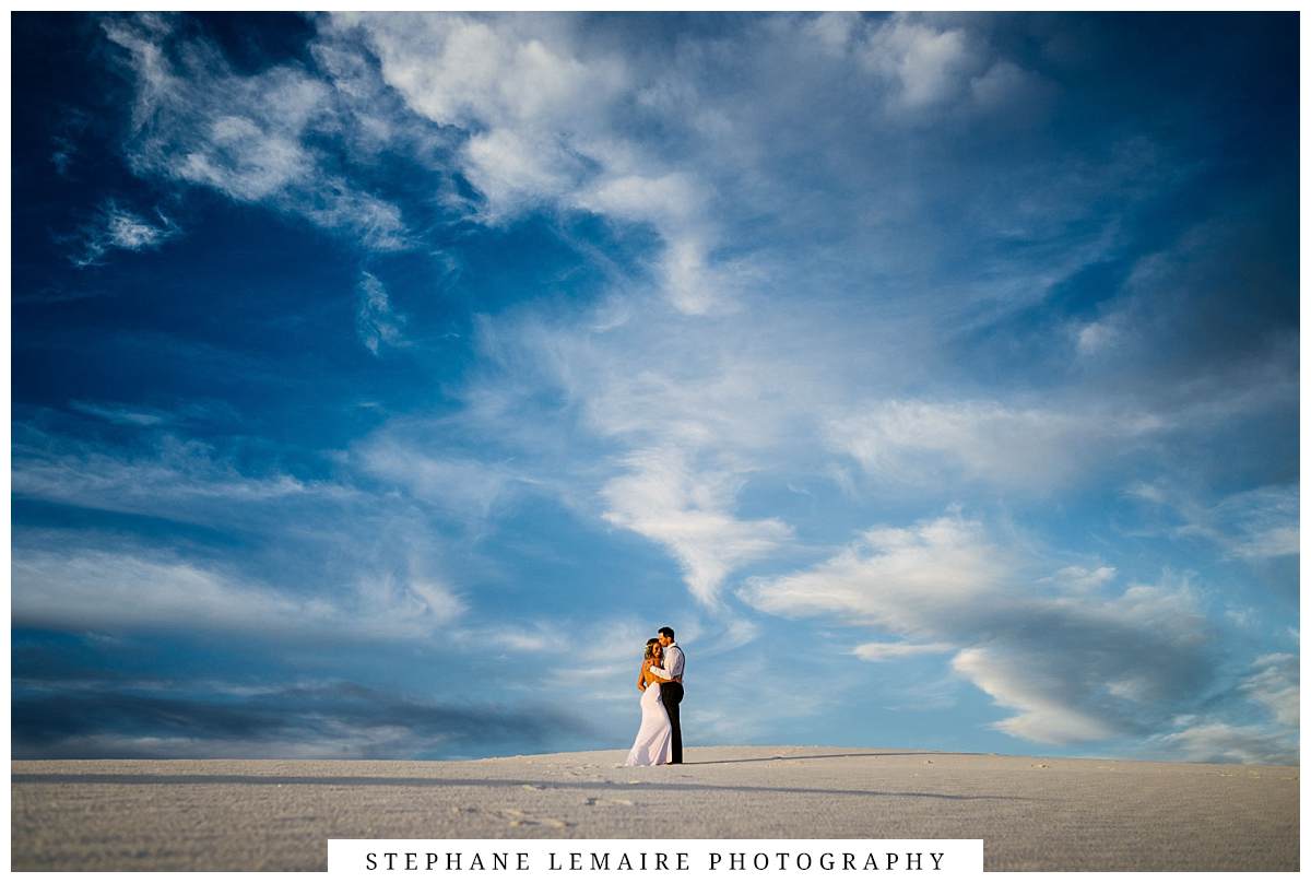 Bride and groom holding hands at sunset at White Sand National monument New Mexico