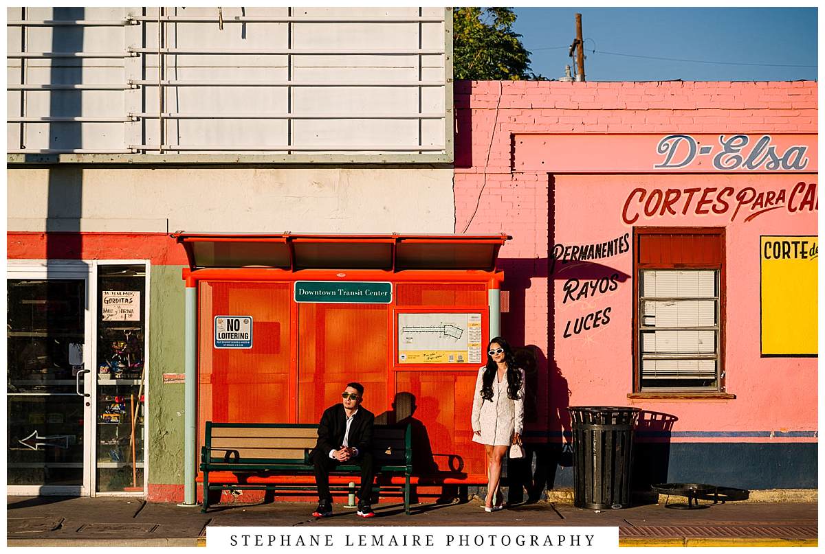 couple sitting at streetcar stop during their downtown El Paso engagement session
