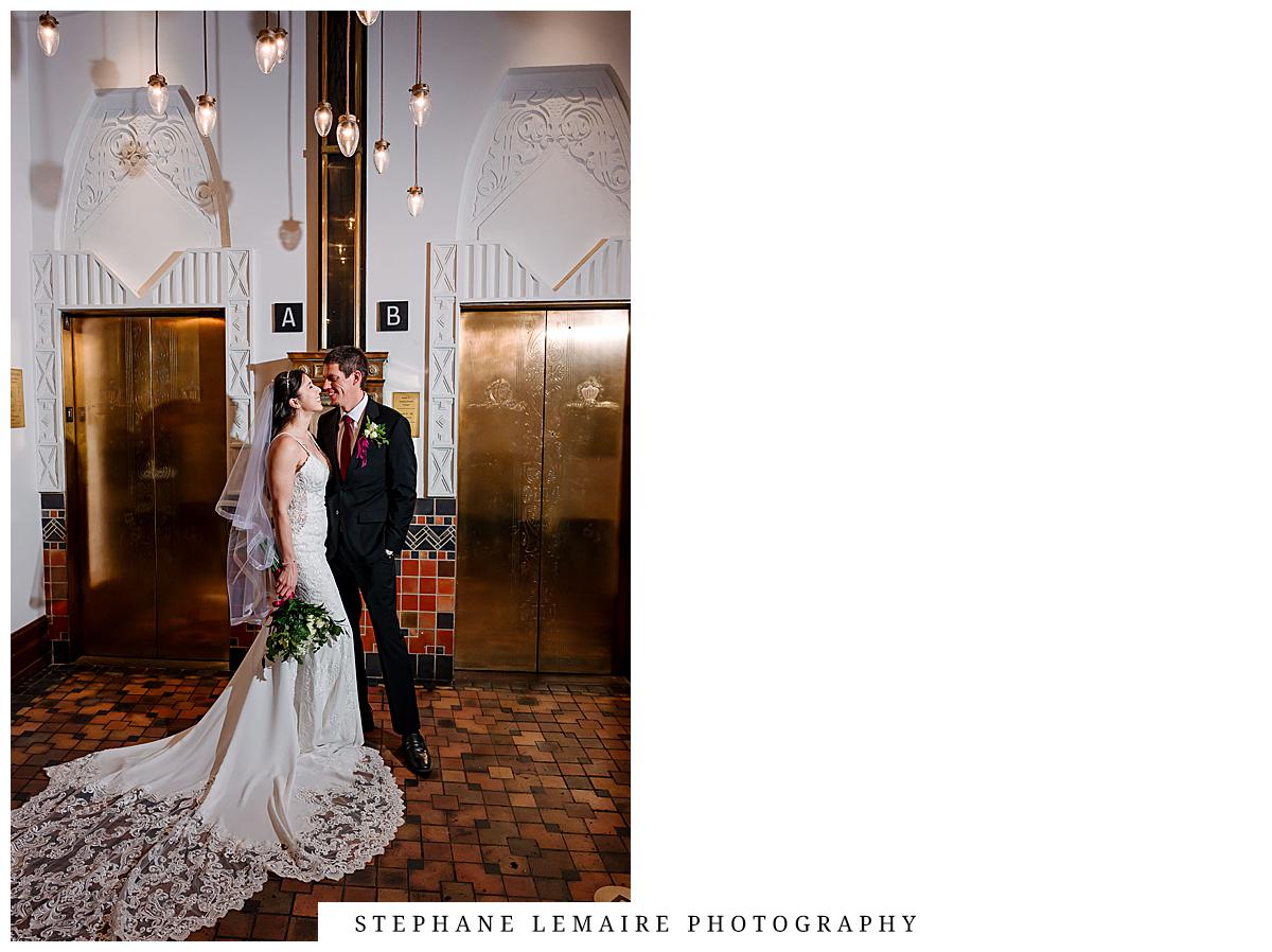 bride and groom in front of elevators at plaza hotel in el paso 