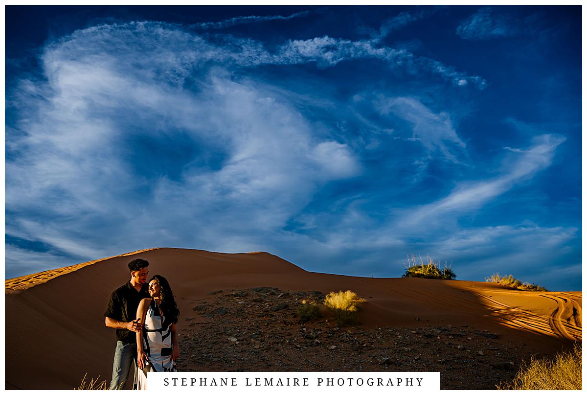couple hugging during their red sands engagement session