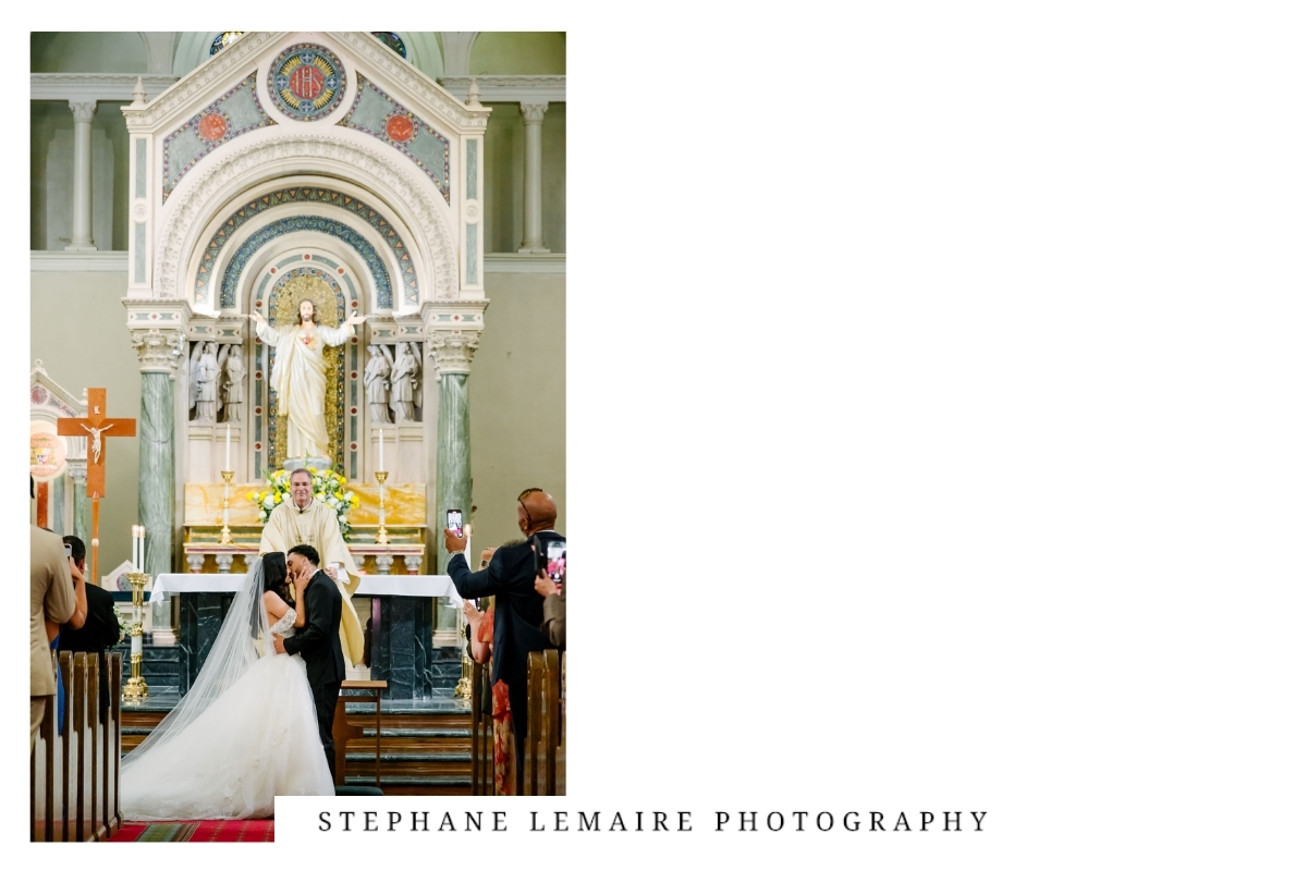 Bride and groom kissing at St. Patrick Cathedral in downtown at