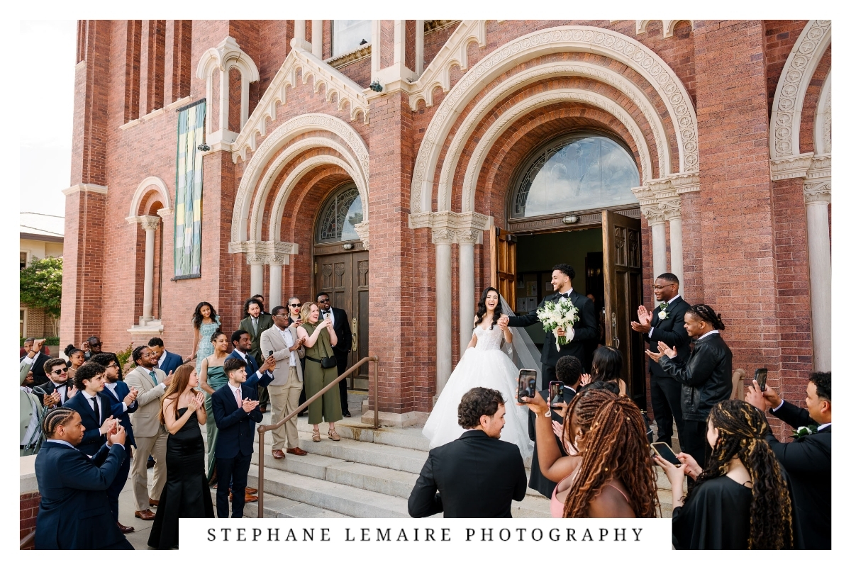 Bride and groom walking out of St. Patrick Cathedral after their ceremony