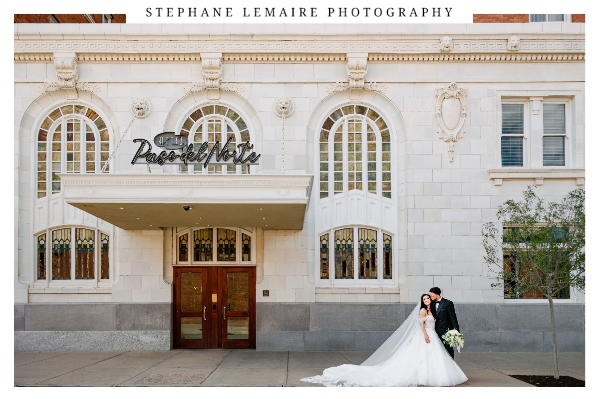 Jessica and David standing beneath the Hotel Paso del Norte sign with the historic hotel façade behind them.