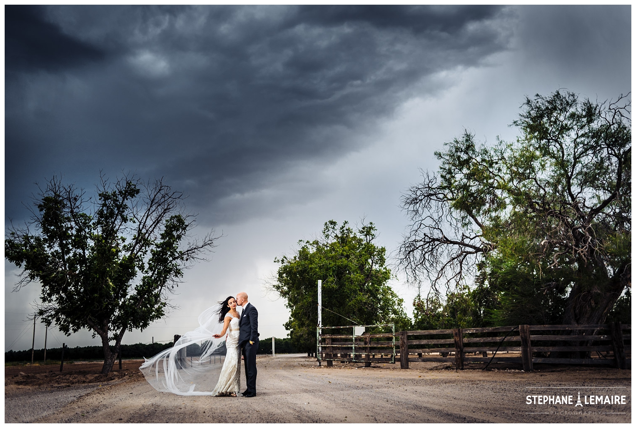 Bride and Groom portraits on a  farm with stormy sky