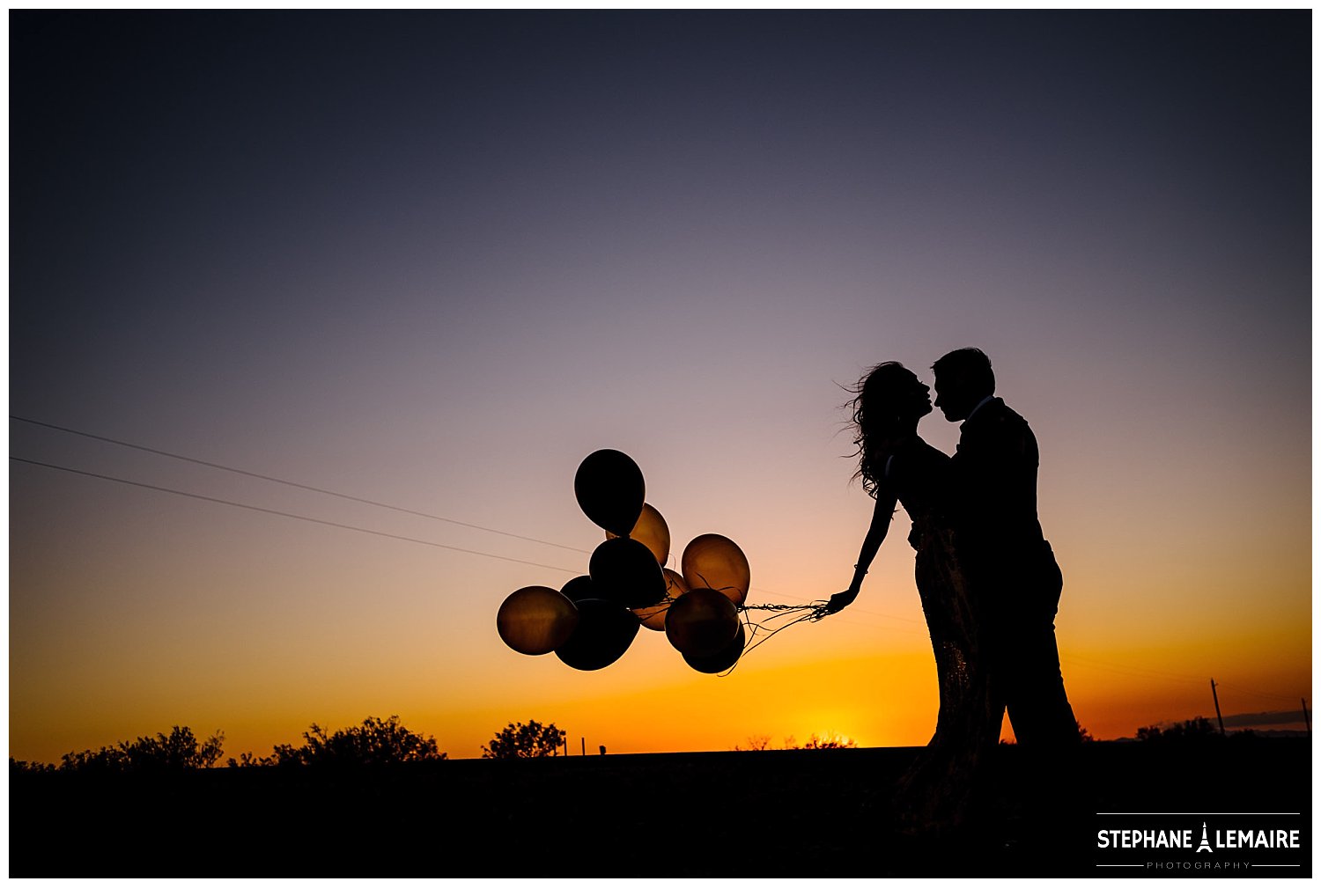 Silhouette of couple at sunset with balloons in Marfa texas by Stephane Lemaire Photography