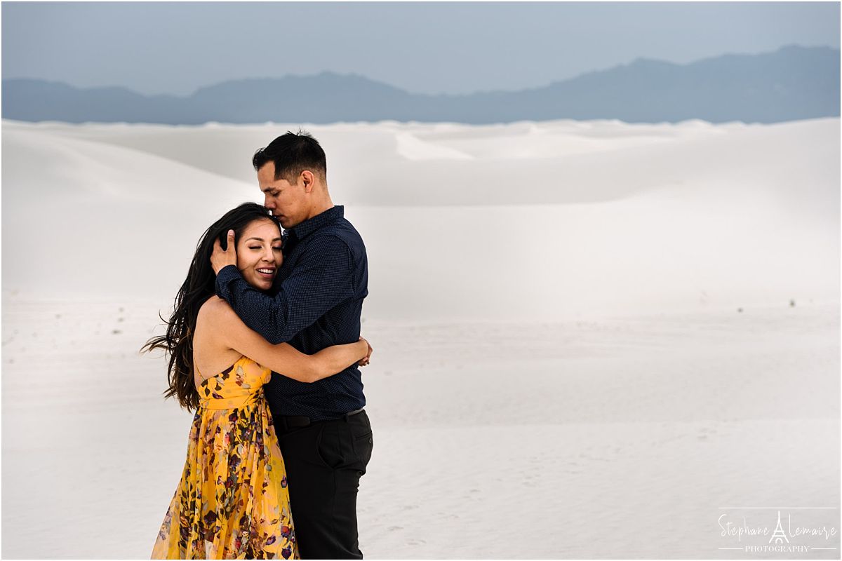 Couple hugging in White Sands New Mexico, photographed by Stephane Lemaire.