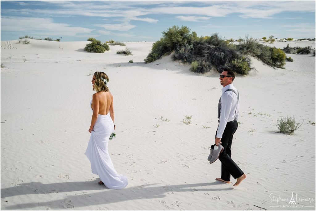 Bride and groom laughing during ceremony at  White Sand National monument New Mexico
