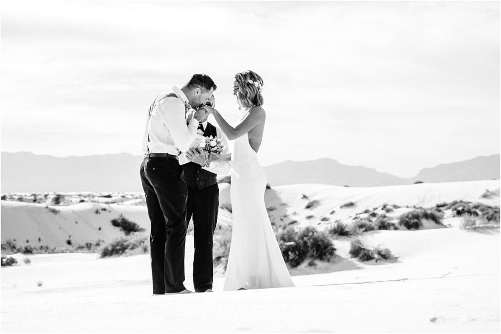 Bride and groom laughing during ceremony at  White Sand National monument New Mexico