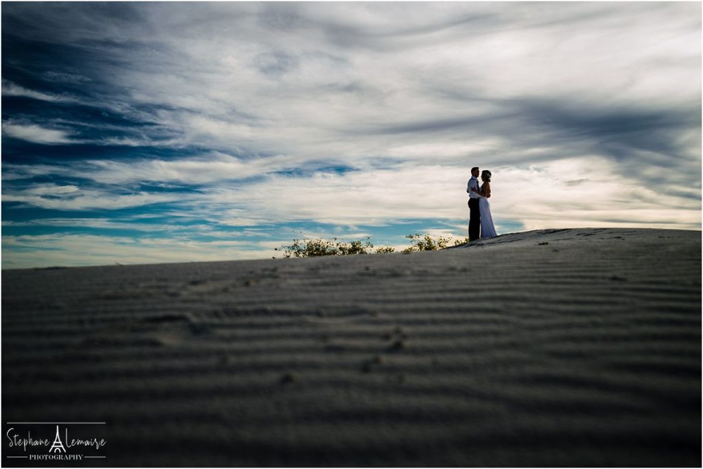 Bride and groom silhouette at  White Sand National monument New Mexico