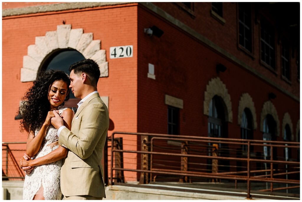 Couple cuddling in front of saint rogers depot in el paso texas 