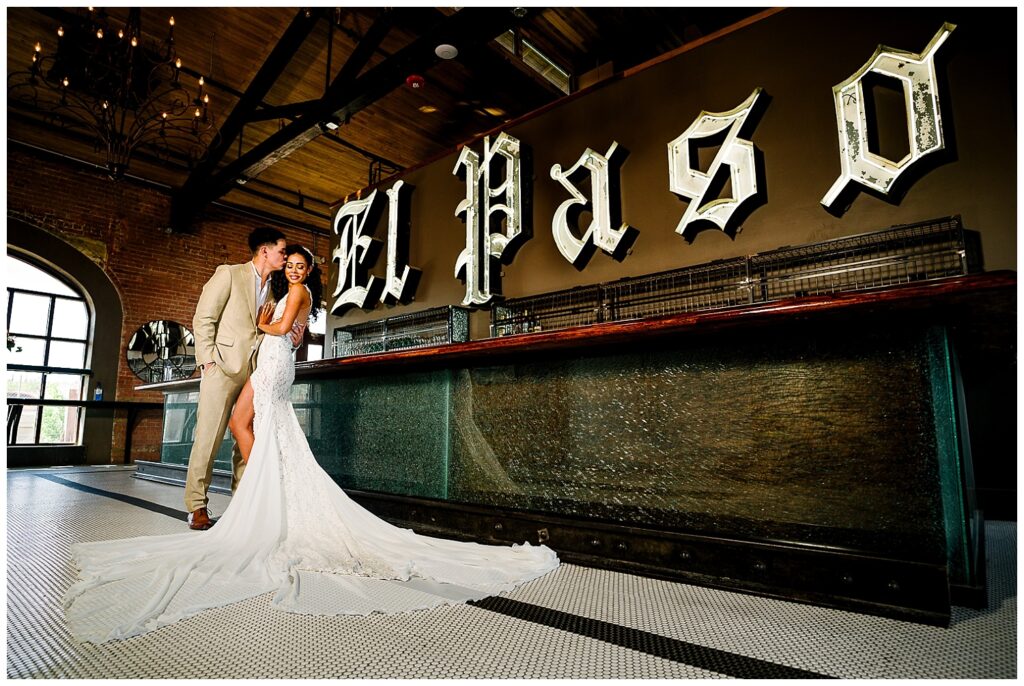 wedding couple in front of el paso bar at saint rogers depot in el paso texas