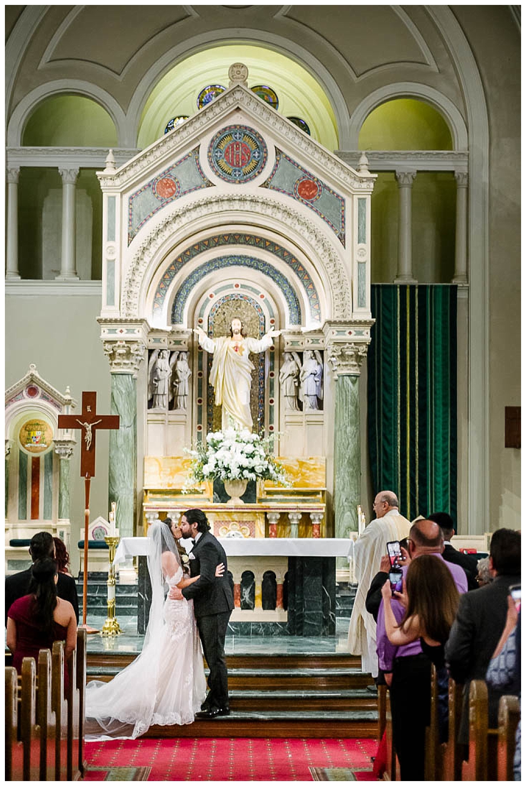bride and groom first kiss at saint patrick cathedral in el paso texas